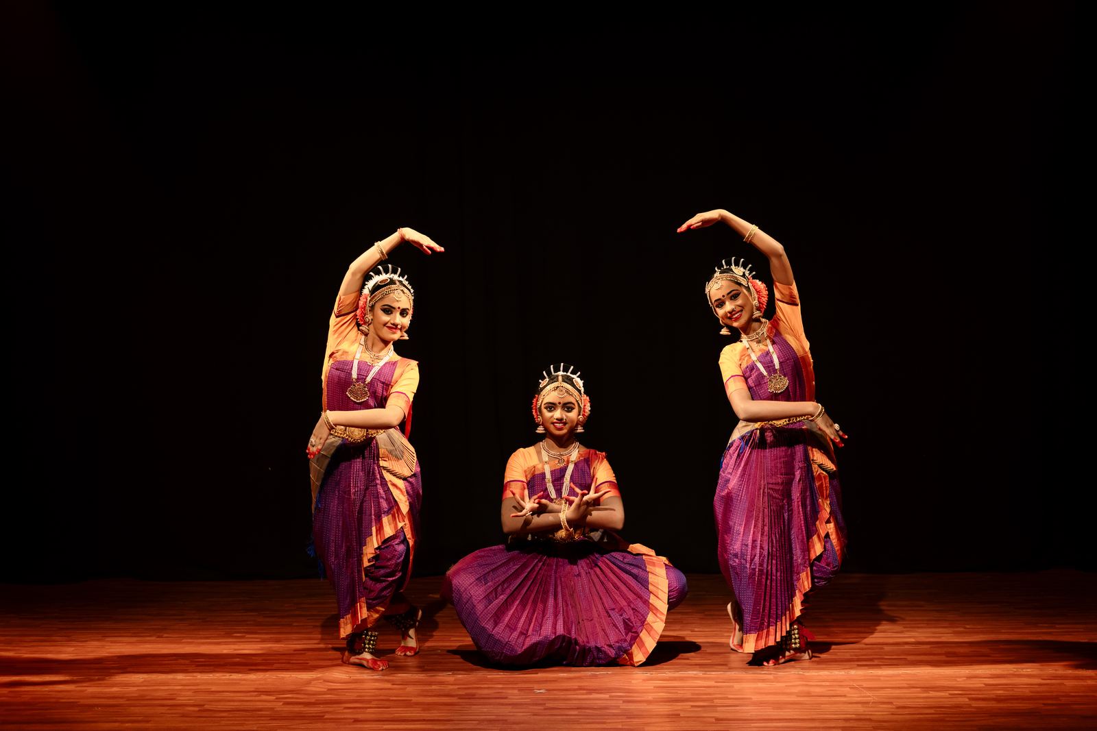Three dancers presenting a balanced Bharathanatyam composition