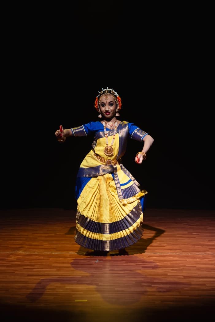 Advanced Bharatanatyam dancer performing a dynamic pose